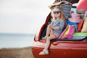 The girl and stuff in the open trunk